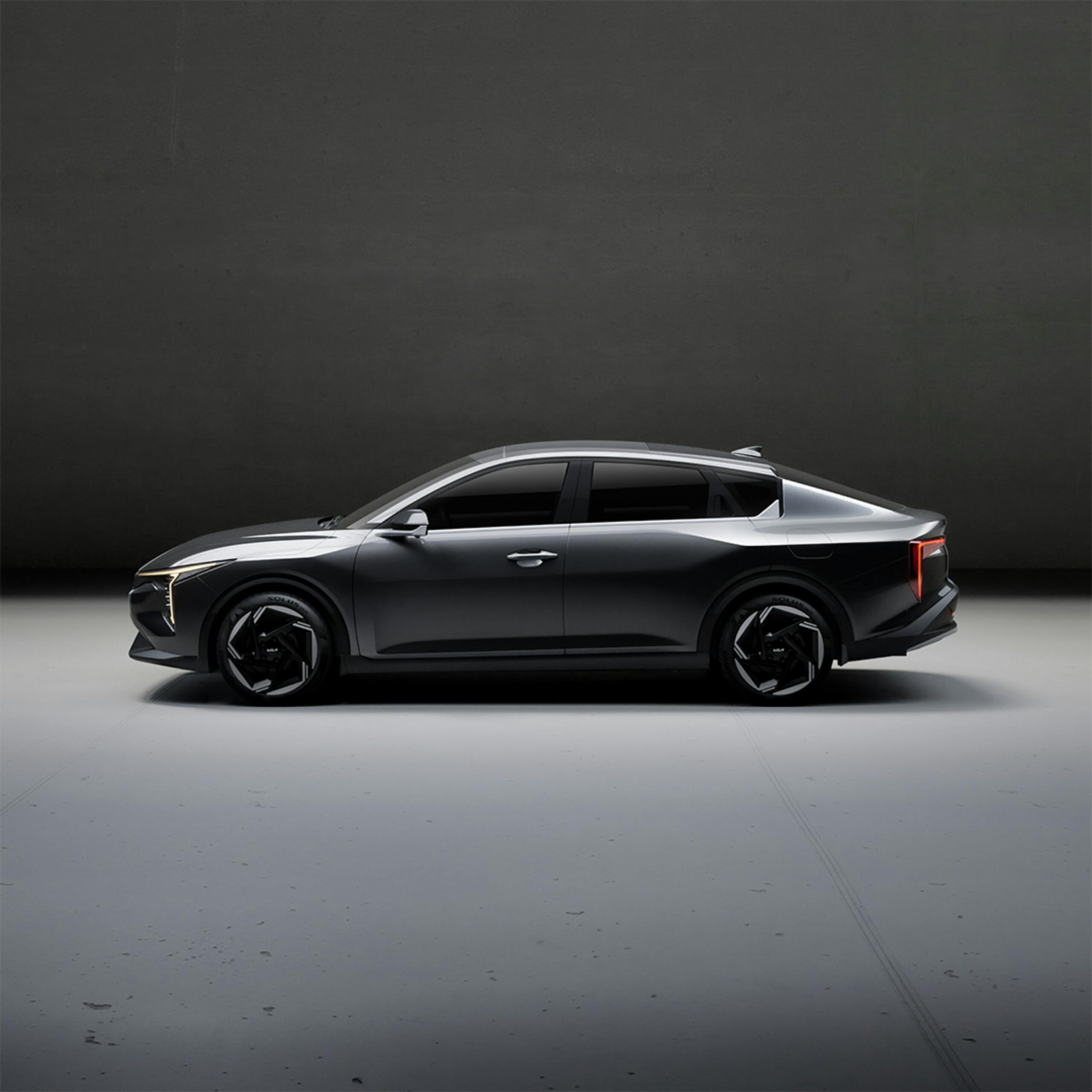 Sleek electric car showcased in a minimalist indoor studio setting, highlighting design and innovation.